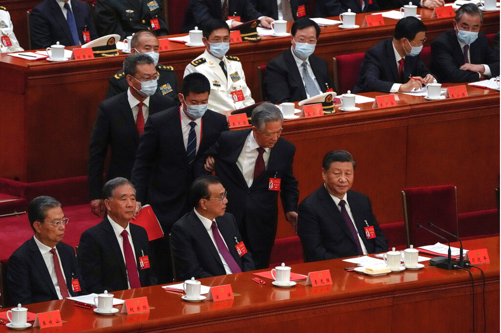 Former Chinese President Hu Jinto, front row second from the right, speaks with party leader Xi Jinping, right, as he is escorted out of the hall during the closing ceremony of the 20th Chinese National Congress at the Great Hall of the People in Beijing, Saturday, Oct. 22. Photo: Andy Wong/ AP Photo