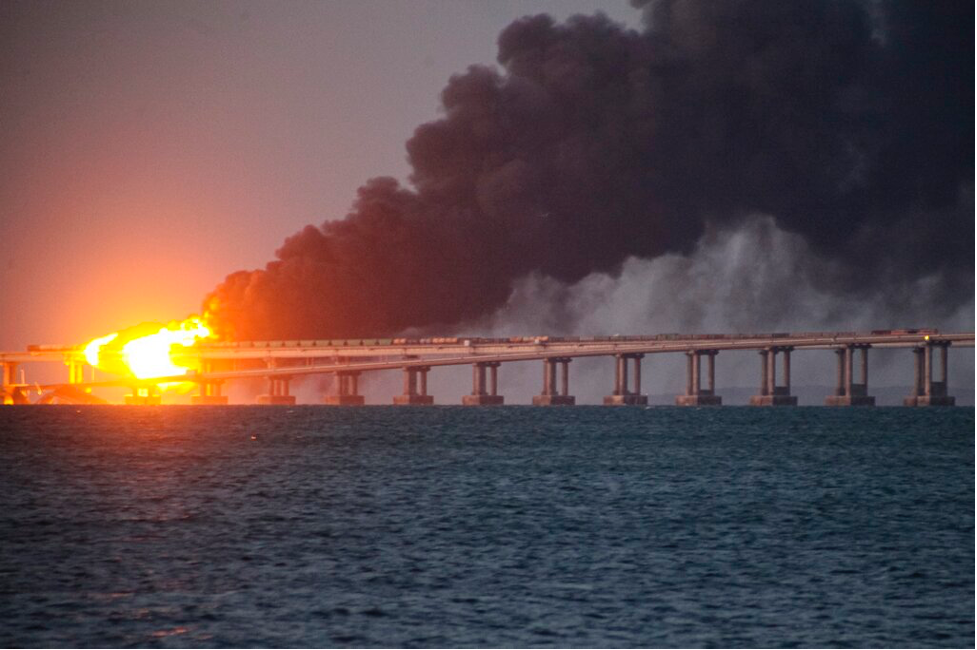 Flame and smoke rise from the Kerch Strait Bridge that connects Russia with occupied Crimea on Oct. 8, 2022. (AP Photo)