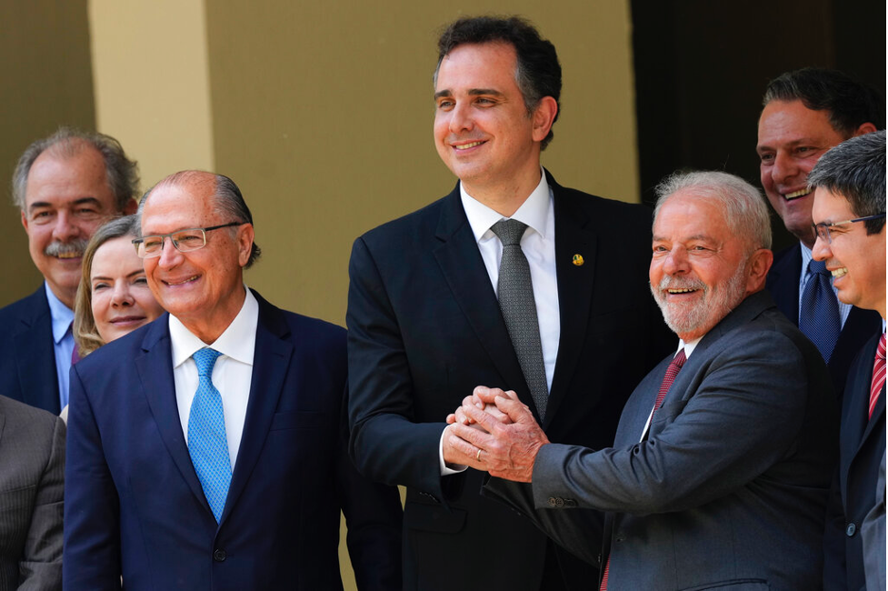 Brazil’s new president, Luiz Inacio Lula da Silva(right) shakes hands with the Senate President on his first day in office on Jan. 1. (AP Photo/Eraldo Peres)