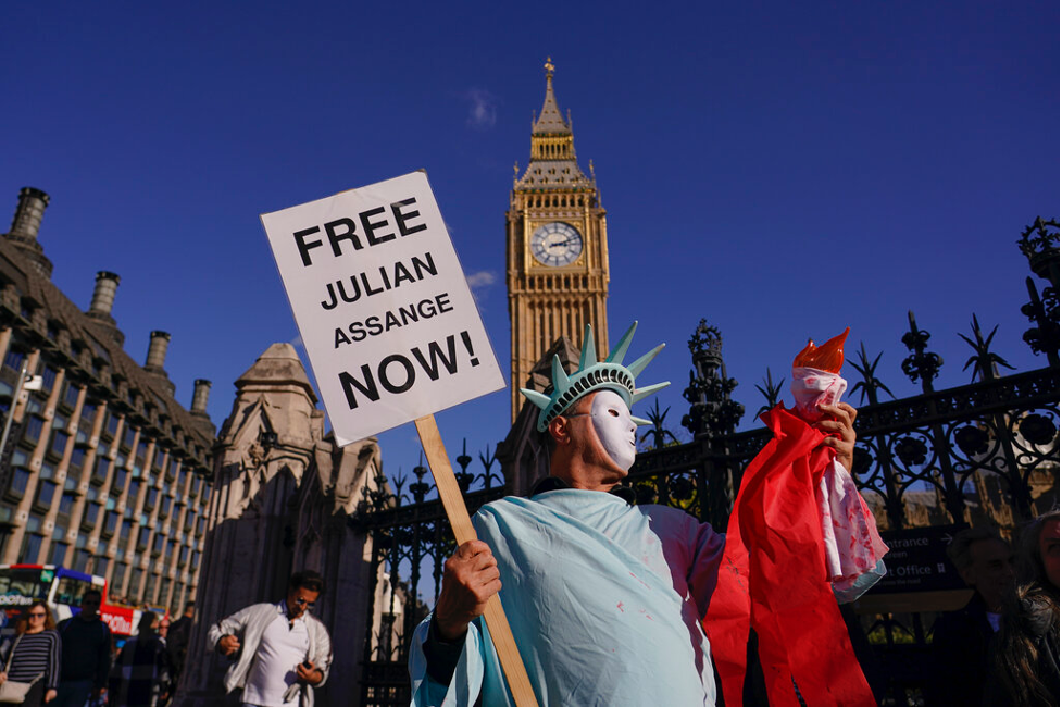 A person dressed as the Statue of Liberty protests against the extradition of Julian Assange to the United States in London, on October 8, 2022. (AP Photo/Alberto Pezzali, File)
