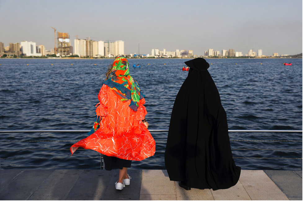 Women presenting different dress codes spend a sunny afternoon around the Persian Gulf in Tehran, Iran on July 6, 2019. (AP Photo/Ebrahim Noroozi)